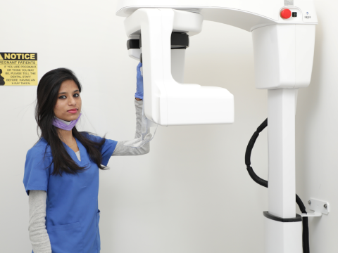 A Women holding mahcine at dental office
